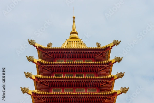 Fototapeta Elista, Kalmykia / Russia - 24 april 2019. The roof of the buddhist Pagoda of Seven Days. Classical buddhist architecture style with elephants heads on the corners