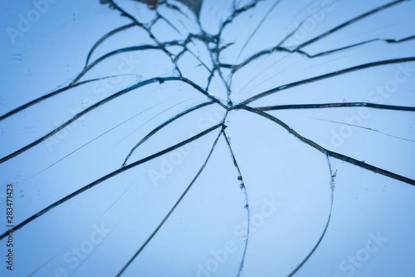 Fototapeta Broken mirror with fragments and cracks close-up.
