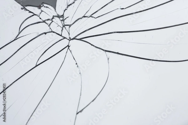 Fototapeta Broken mirror with fragments and cracks close-up.