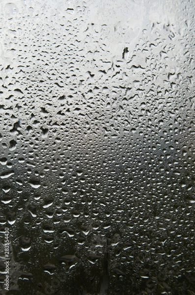 Fototapeta Windowpane in rain drops.