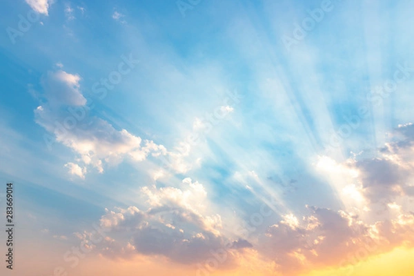 Fototapeta Besutiful ray of sunlight breaking through clouds at sunset.