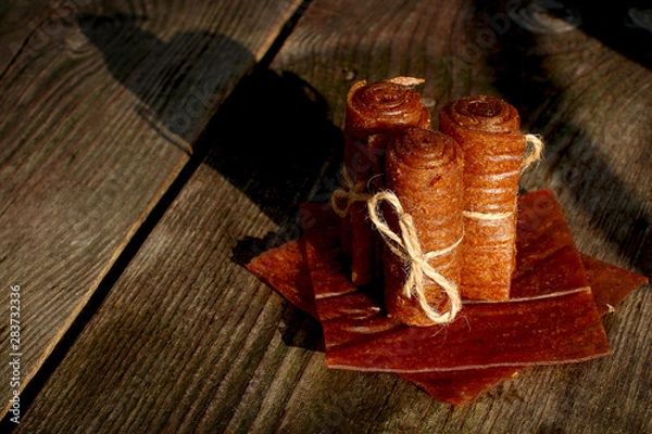Fototapeta Handmade apple pastilles rolls with linen thread lined with leaf marshmallows on wooden background