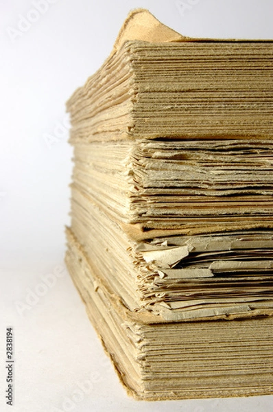 Fototapeta antique books piled front a silver background