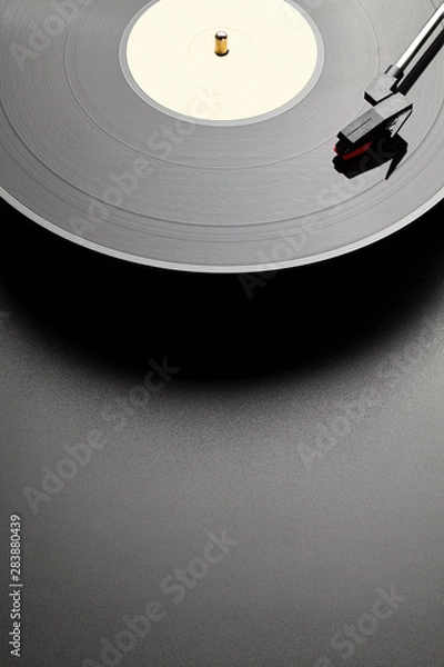 Fototapeta Black vinyl record player on black table background