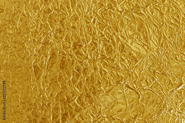 Fototapeta Gold foil leaf shiny texture, abstract yellow wrapping paper for background and design art work.