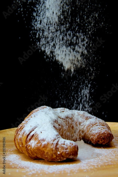 Obraz icing sugar falling  on Croissant