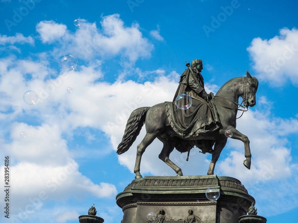 Fototapeta Black statue with floating soap bubbles