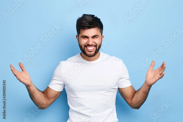Fototapeta happy successful man rejoicing at big sales on clothes, happiness, unexpected good fortune, victory of his favourite team. studio shot