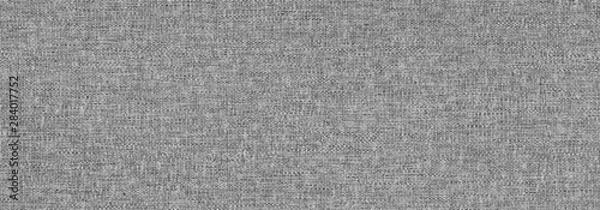 Fototapeta The Grunge texture of the wrong side of knitted fabric. Monochrome background of wavy knit fibers with spots, halftone and noise. For posters, banners, retro and urban design