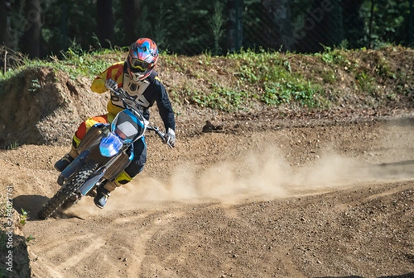 Fototapeta Motocross rider on a trail during a training