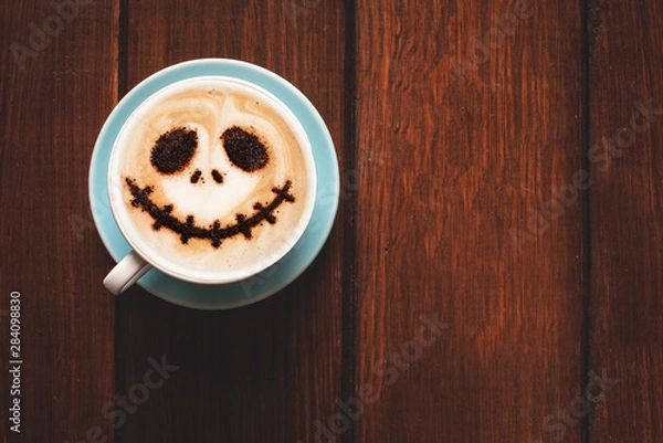 Fototapeta Cup of coffee with scary Jack's face. Halloween background. Halloween party. 