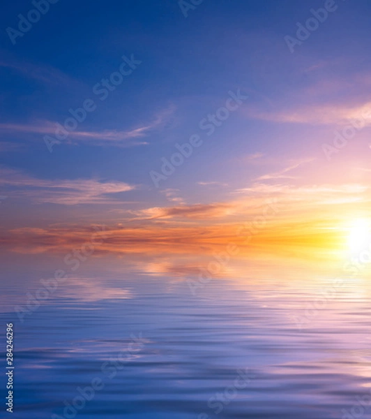 Obraz Sunset over the sea on a spring cloudy evening.