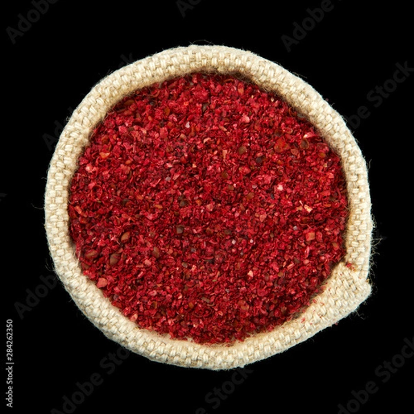 Obraz Mixtures of peppers in a bag isolated on a black background. View from above. Seasoning on isolate. Dry spices.