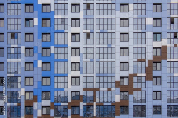 Fototapeta facade of a modern glass bright multi-colored multi-storey building with windows