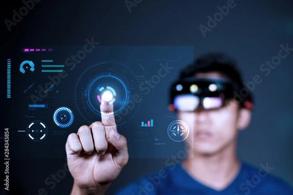 Fototapeta Using VR glass to enter virtual reality world. Future Technology Magic Equipment. Men controls interfaces in augmented reality world