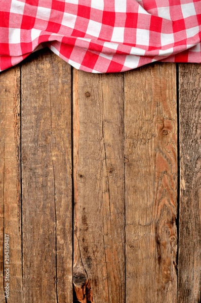 Fototapeta Red checkered tablecloth top frame on vintage wooden table background - view from above - vertical photo