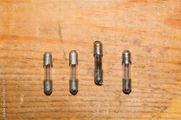 Fototapeta Row of fuses with burned out fuse. safety device for overcurrent protection. protection of an electrical circuit