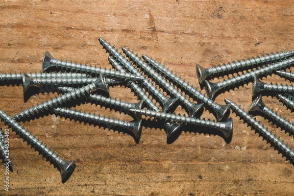 Obraz Screws on a wooden background.working tools