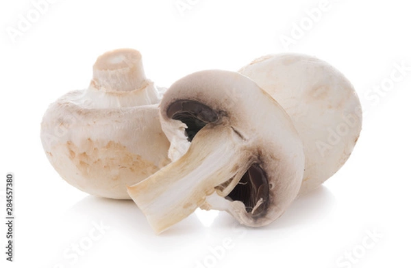 Fototapeta mashrooms whole and sliced champignons isolated on white background