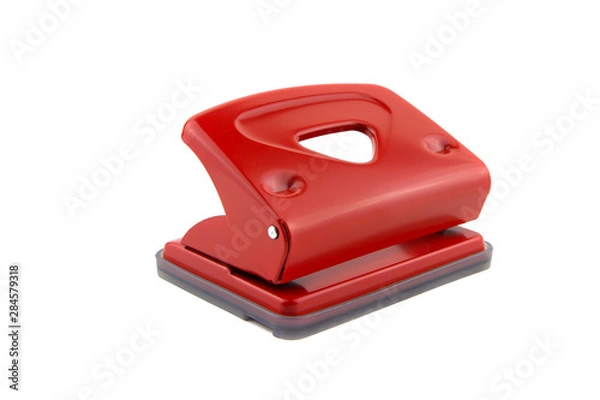 Fototapeta Red office paper hole puncher, isolated on white background