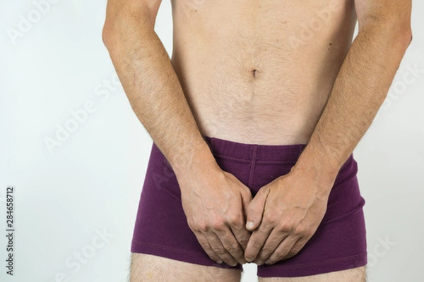 Obraz man with hands in purple underpants, isolated on white