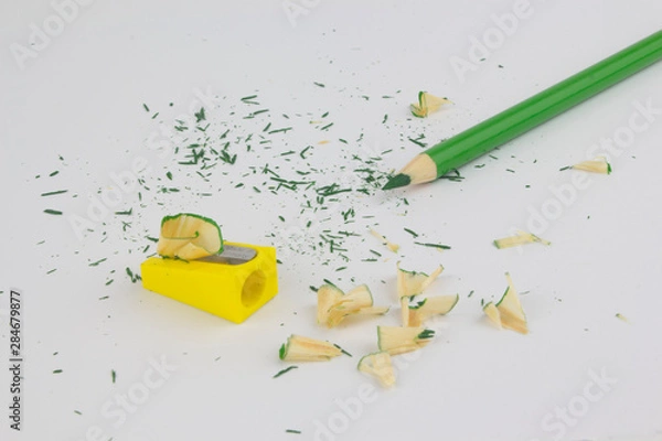 Obraz Green pencil on white background with sharpener