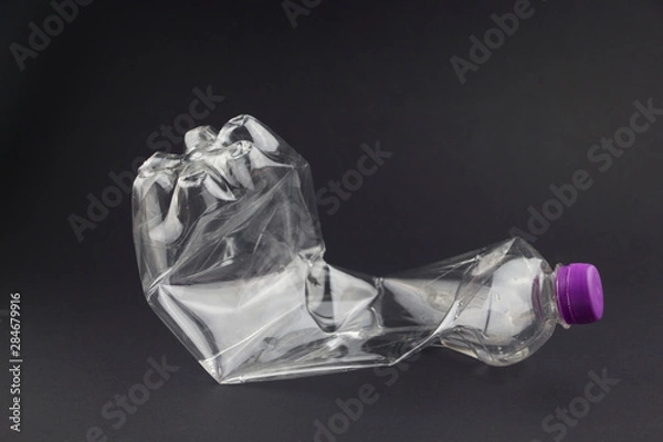 Obraz Old plastic bottle on a black background