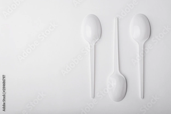 Obraz Three plastic spoon on white background.