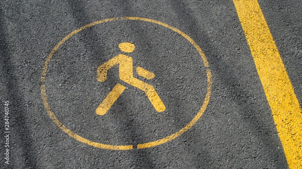 Fototapeta Road sign WALK yellow markup paint bicycle path asphalt texture