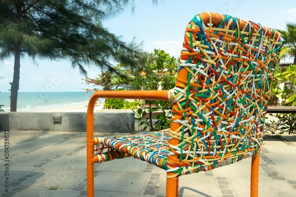 Fototapeta Chair backrest of variety colors of rattan lines that are alternately woven into mesh style