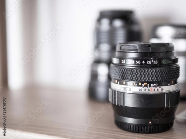 Obraz Selective focus of old camera lens on wood self.