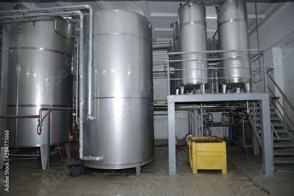Fototapeta shiny tanks or barrels at a beer and wine factory. Industry Brewing and winemaking. Equipment for the winery and brewing industrial 