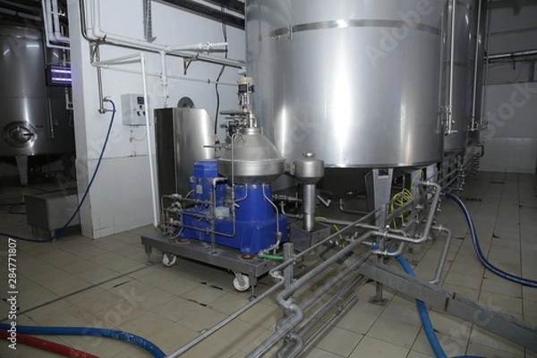 Fototapeta shiny tanks or barrels at a beer and wine factory. Industry Brewing and winemaking. Equipment for the winery and brewing