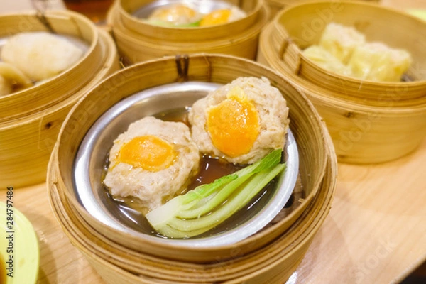 Obraz Pork with salted egg Dim Sum in Bamboo Steamer Basket.