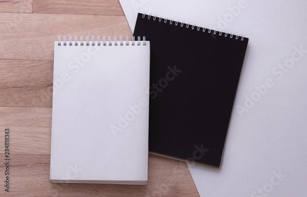 Fototapeta notebooks on wooden and white background