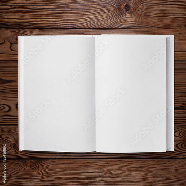 Fototapeta Open book with blank pages, view from above, on dark wooden background