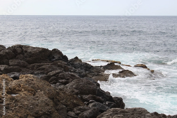 Fototapeta Waves crashing on rocks