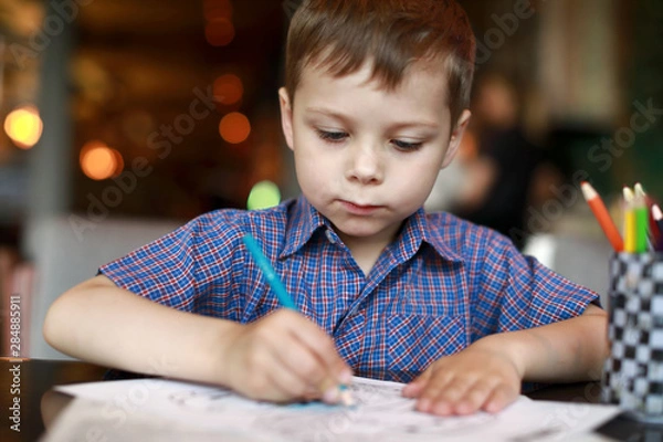 Fototapeta Boy drawing with pencil