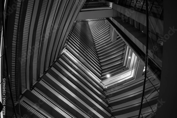 Obraz Black-and-white shot of the inside of a skyscraper and the pattern the levels create