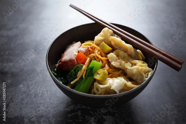 Fototapeta Egg noodle with red roasted pork and wonton on table.
