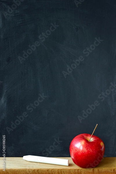 Fototapeta Close-up black chalk board in chalk stains chalk board and red apple, selective focus, copyspace