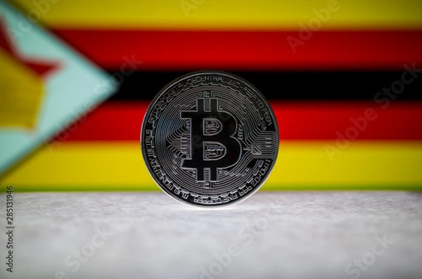 Fototapeta Physical silver version of Bitcoin (BTC) and Zimbabwe Flag on the background. Conceptual image for investors in cryptocurrency and Blockchain Technology.