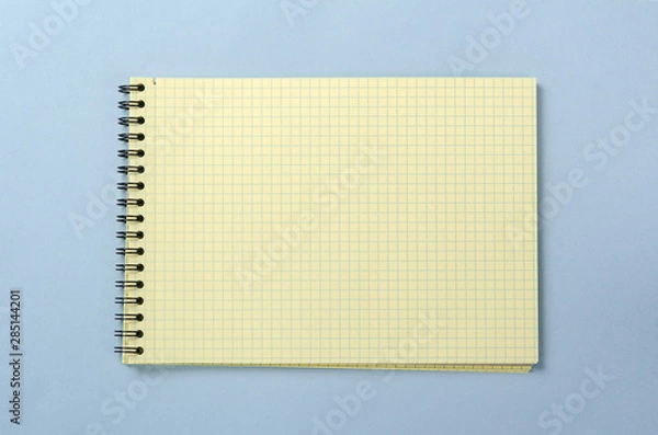 Obraz Yellow spiral notebook for notes with blank sheet. Flat lay