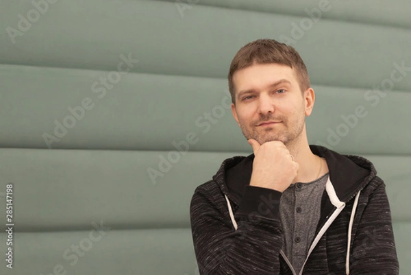 Obraz Photo shoot in cafe. Hand on chin. Assessment of the situation and smile. Waiting for actions.