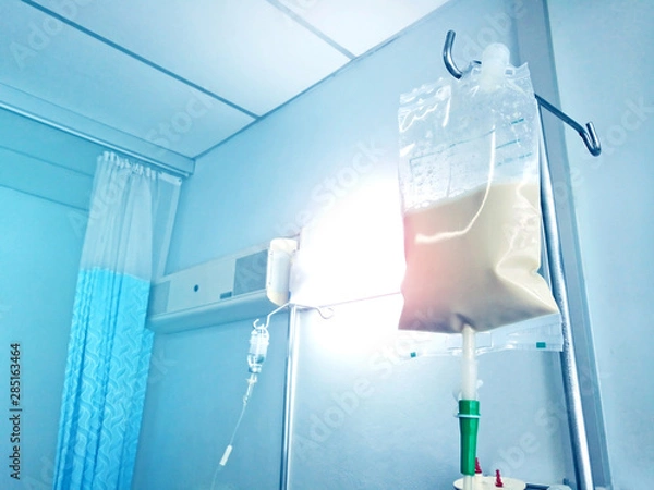 Obraz Bluetone of Enteral feeding bag on IV pole in patian room.