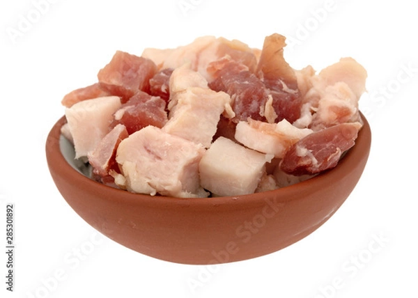 Fototapeta Pancetta sliced into cubes in a small bowl on a white background