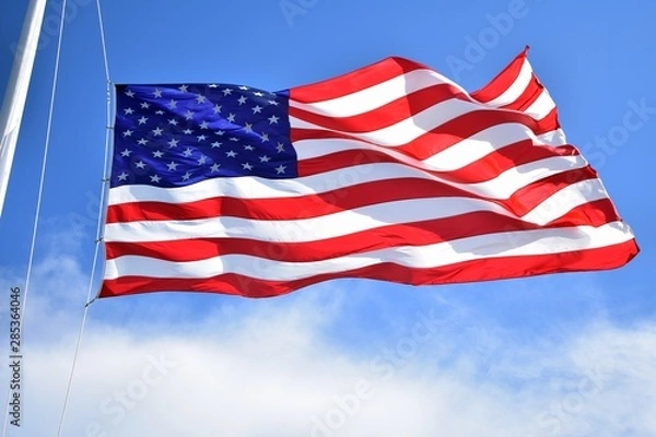 Fototapeta American flag flying high on a summer day