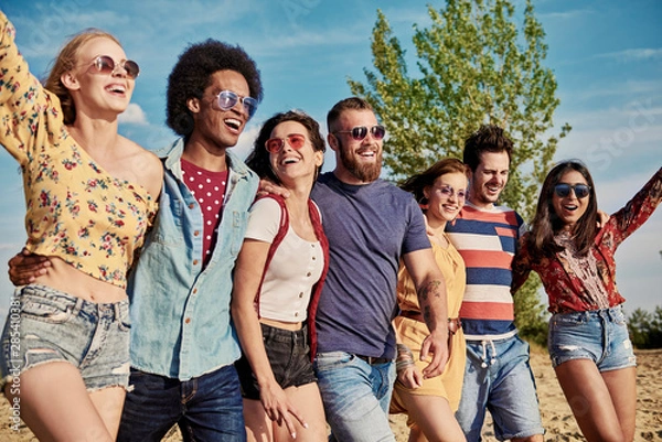 Fototapeta Young smiling people in a row on the fresh air