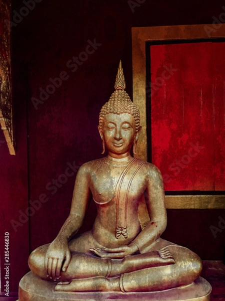 Fototapeta golden buddha statue, The face of gold buddha statue, Close up of the old Thai buddha with wooden wall background in art of religion concept