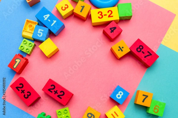 Fototapeta child kid colorful education toys cubes with numbers math pattern background on the bright background. Flat lay. Childhood infancy children babies concept.